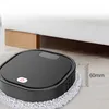 A black robot vacuum cleaner is shown on a wooden floor, positioned under a white bed with wooden supports. A measurement graphic indicates 60mm. Produktbild-Vorschau