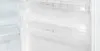 Close-up view of the inside of a refrigerator with clear plastic shelves and compartments. Produktbild-Vorschau