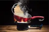 A red wok pan with noodles being tossed over a gas burner, with steam rising. Produktbild-Vorschau