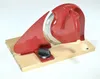 A red manual slicer is placed on a wooden board against a white background. Podgląd zdjęcia produktu