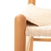 A close-up shot of a wooden chair with a woven seat. Podgląd zdjęcia produktu