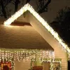 A house decorated with Christmas lights at night. Produktbild-Vorschau