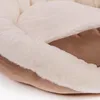 A close-up view of a soft, plush dog bed with cream-colored fuzzy lining and a brown exterior. Produktbild-Vorschau