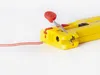 A yellow wire stripper tool is shown with a red and white wire inserted into it. Produktbild-Vorschau