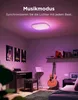 A room with a ceiling light that is lit up with purple and pink colors, a piano, a guitar, and posters on the wall. Produktbild-Vorschau