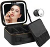 A woman applying makeup in front of a lighted mirror on a makeup case. Anteprima dell’immagine prodotto