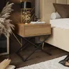A bedroom scene with a nightstand next to a bed, featuring a lamp, books, and decorative items. Produktbild-Vorschau