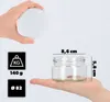 A hand holds a white lid above a small glass jar, with dimensions and weight information displayed on black squares to the left. Podgląd zdjęcia produktu