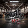 A black motorcycle is lifted on a red hydraulic scissor lift in a workshop. Produktbild-Vorschau