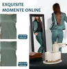 A split image showing a garment before and after steaming, with a woman in a suit reflected in a mirror and a steaming device in the foreground. Produktbild-Vorschau
