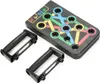 A black push-up board with colored lines and circles, along with two black handles, is displayed on a white background. Produktbild-Vorschau