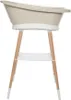 A taupe baby bathtub on a wooden stand with a white shelf. Produktbild-Vorschau