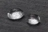 Two water droplets on a dark gray textured surface. Produktbild-Vorschau