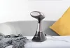 A Russell Hobbs handheld garment steamer stands on a table next to a piece of clothing. Produktbild-Vorschau