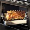 A roasted rack of lamb is shown inside an oven, resting on a roasting rack and pan. Produktbild-Vorschau