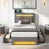 A modern bedroom setting featuring a grey upholstered bed with integrated LED lighting and a charging station. Produktbild-Vorschau