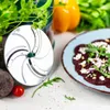 A close-up of a food processor blade next to a beet salad. Anteprima dell’immagine prodotto
