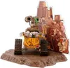 A Wall-E figure is displayed on a rocky base with a backdrop of debris. Anteprima dell’immagine prodotto