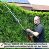 A man is using a long-handled hedge trimmer to trim a green hedge in front of a house with solar panels. Produktbild-Vorschau