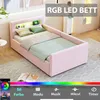 A pink upholstered bed with a headboard featuring integrated LED lighting and storage compartments, set in a bedroom environment. Náhľad obrázku produktu