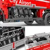 A collage of close-up images showing details of a red and gray toy vehicle, likely a fire truck or airport vehicle, with transparent engine components and a liftable platform. Voir les images du produit