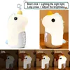 A collage of images showing a unicorn-shaped night light and alarm clock, demonstrating its features and brightness levels. Produktbild-Vorschau
