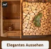 A sauna interior with a stack of firewood next to it, and a bundle of greenery hanging from the firewood. Produktbild-Vorschau