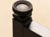 A close-up view of a black adjustable knob on a black metal furniture leg. Produktbild-Vorschau