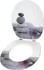 An open toilet seat with a decorative image of stacked stones and a purple flower. Produktbild-Vorschau