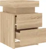 A close-up, angled view of a light brown wooden nightstand with three drawers. Náhľad obrázku produktu