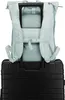 A light blue backpack is placed on top of a black suitcase. Náhľad obrázku produktu