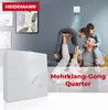 A family is playing in a living room, with a product in the foreground. Produktbild-Vorschau