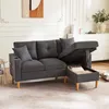 A dark gray sectional sofa with its storage ottoman open, revealing stored items, in a well-lit living room. Podgląd zdjęcia produktu