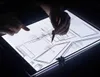 Hands are shown using a light pad to trace a blueprint. Náhled obrázku produktu