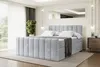A bedroom scene with a light gray upholstered bed as the main focus. Produktbild-Vorschau