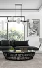 A modern living room with a black leather sofa, a black coffee table with glass top, and a black chandelier with white glass globes. Náhled obrázku produktu