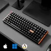 A black mechanical keyboard with copper accents is shown on a gray desk. Voir les images du produit