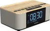 A digital clock radio with a wood-grain top and gray speaker grilles, shown from a slightly elevated front-side angle against a white background. Anteprima dell’immagine prodotto