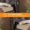 A close-up view of a bed frame with side pockets, highlighting its storage features. Produktbild-Vorschau