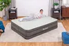 A woman is lying on an inflatable mattress in a bedroom setting. Produktbild-Vorschau
