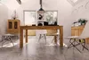 A dining room with a wooden table and chairs, set up for a meal. Produktbild-Vorschau