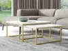 Two nesting coffee tables with white tops and gold metal frames are placed on a gray rug in front of a sectional sofa. A green bowl sits on the larger table. Náhľad obrázku produktu