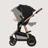 A side view of a black and gold baby stroller, with an arrow indicating a rotating motion. Produktbild-Vorschau