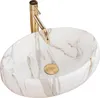A white oval sink with gold veining and a gold faucet. Podgląd zdjęcia produktu