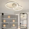 A modern ceiling light with two rings, shown in a bedroom setting and with feature callouts. Podgląd zdjęcia produktu