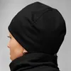 Side profile of a person wearing a black beanie. Anteprima dell’immagine prodotto