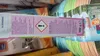 A close-up of a product box with text and symbols, placed among other products. Produktbild-Vorschau