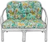 A close-up studio shot of a floral patterned cushion on a silver rattan bench. Produktbild-Vorschau