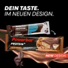 Two Powerbar protein bars are shown with a chocolate liquid splash background. Text overlays highlight the product and its new design. Produktbild-Vorschau