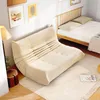 A cozy living room scene with a beige sofa and a bed. Produktbild-Vorschau